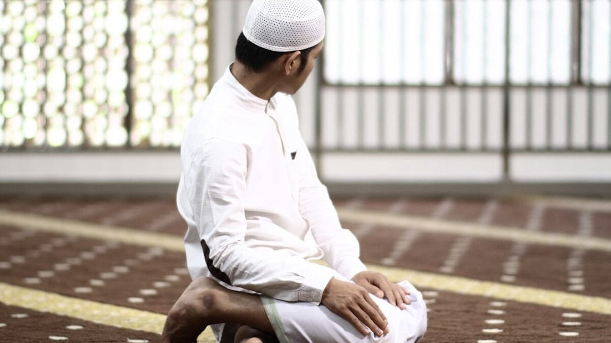 man kneeing in buiding